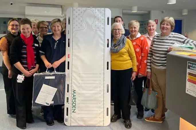 Auxiliary members hand over the new patient transfer board at Narrandera Hospital. Photo: Supplied