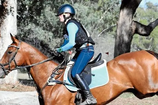 Kate Langley tests out the water jump on Narrandera\\u2019s cross country course in preparation for the Super Cross. Photo: Helen Langley