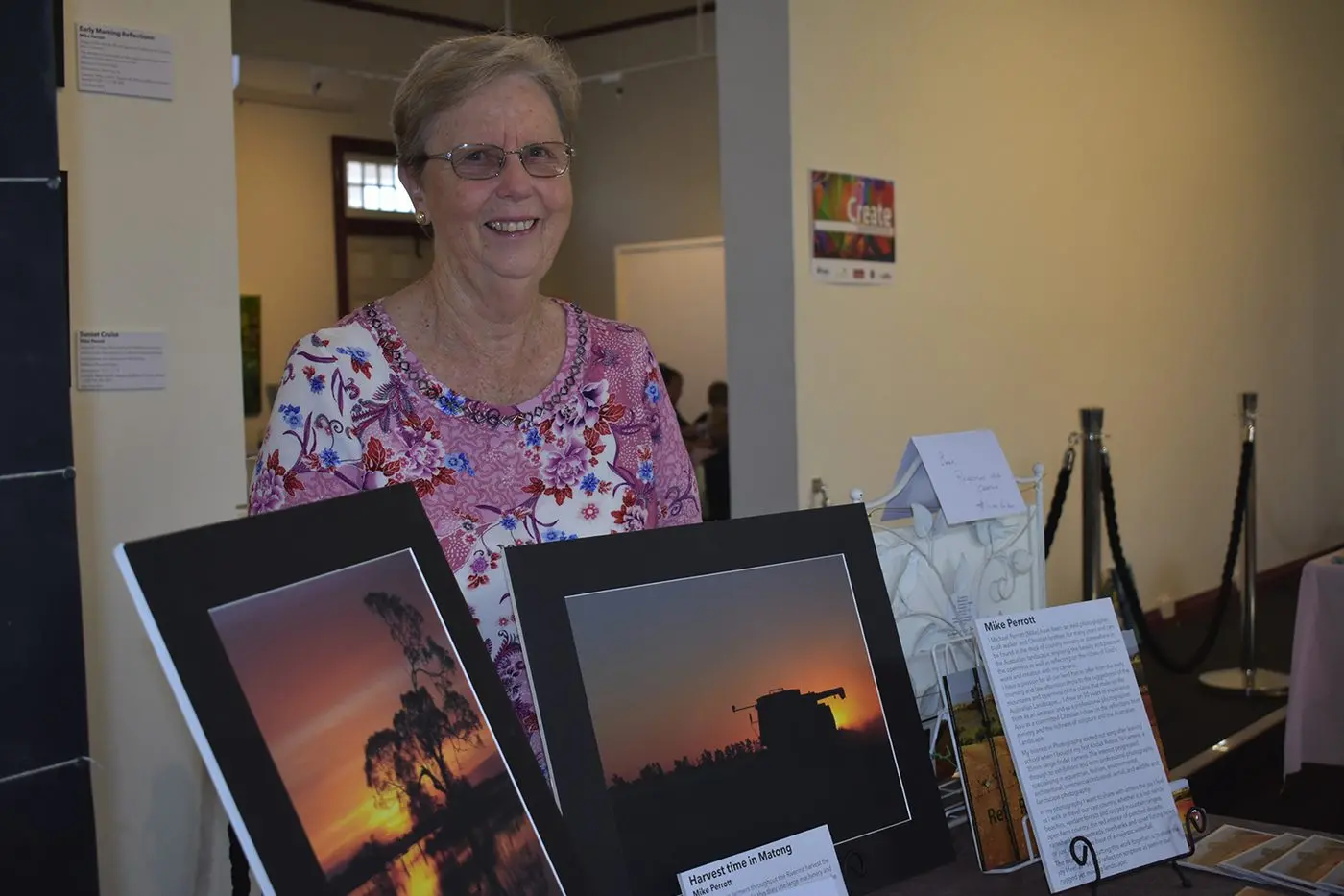 Kerrie Perrott holds photographs of a Matong grain harvest by Mike Perrott on display during the Arts and Craft Fair. Photo: Rustty Lake-Connolly