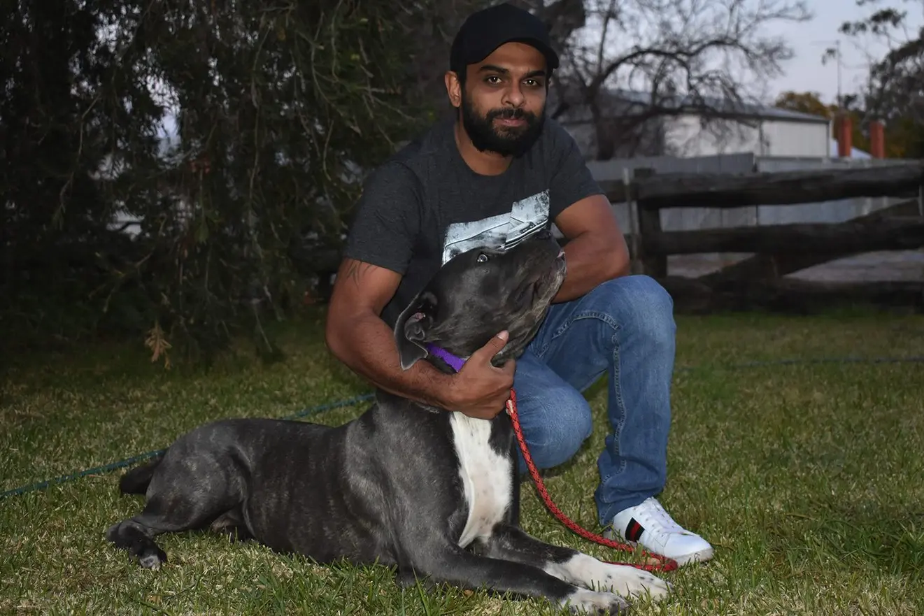 Luna with her owner Asith Pieris at home in Narrandera. Photo: Rustty Lake-Connolly