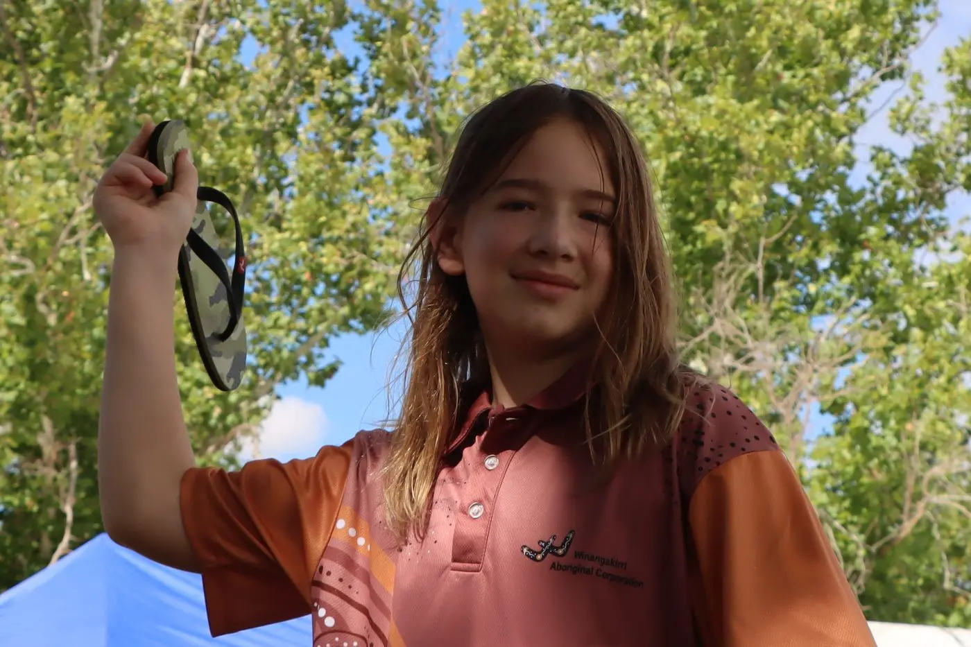 Harry Kschenka gets into the swing of things at the thong throw competition at Narrandera Sports-ground during Australia Day celebrations. Photo: Sean Cunningham