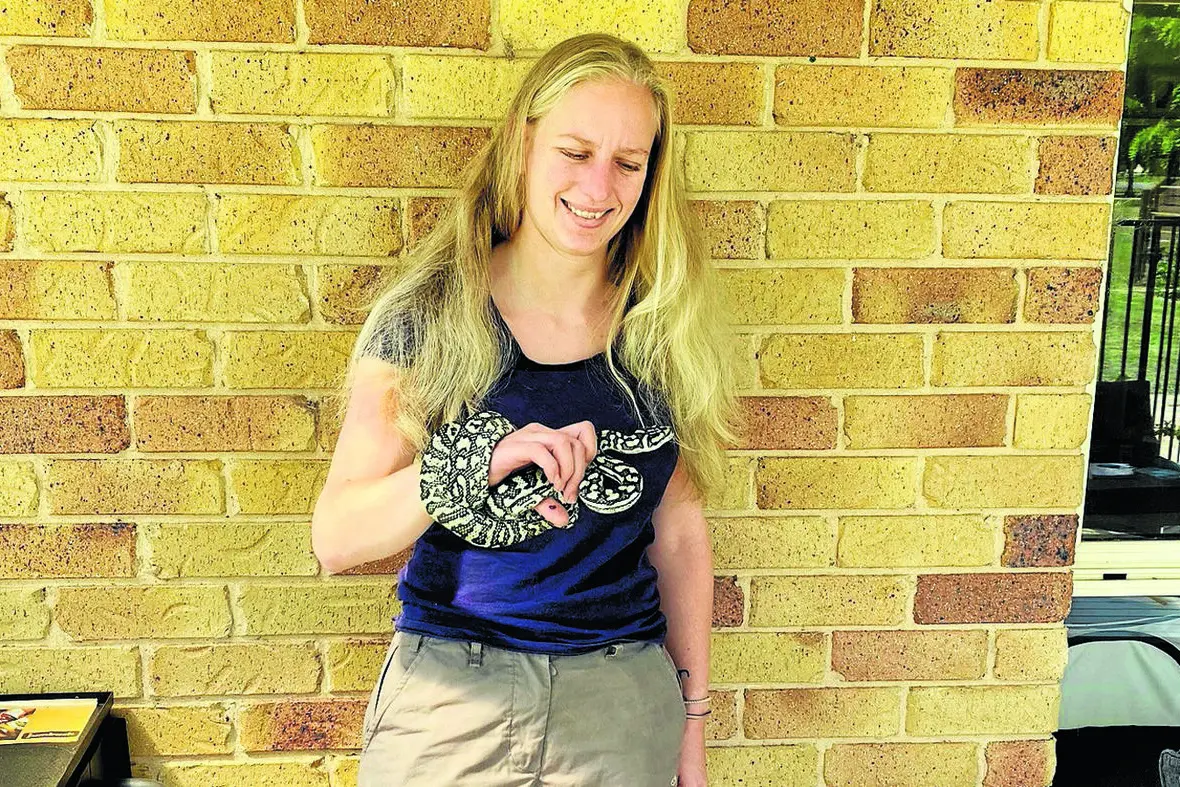 Meg\\u2019s Reptile Relocation Services principal Meg Welsh and her Murray Darling python Rumble-Snake Skin. Photo: Claire Williams
