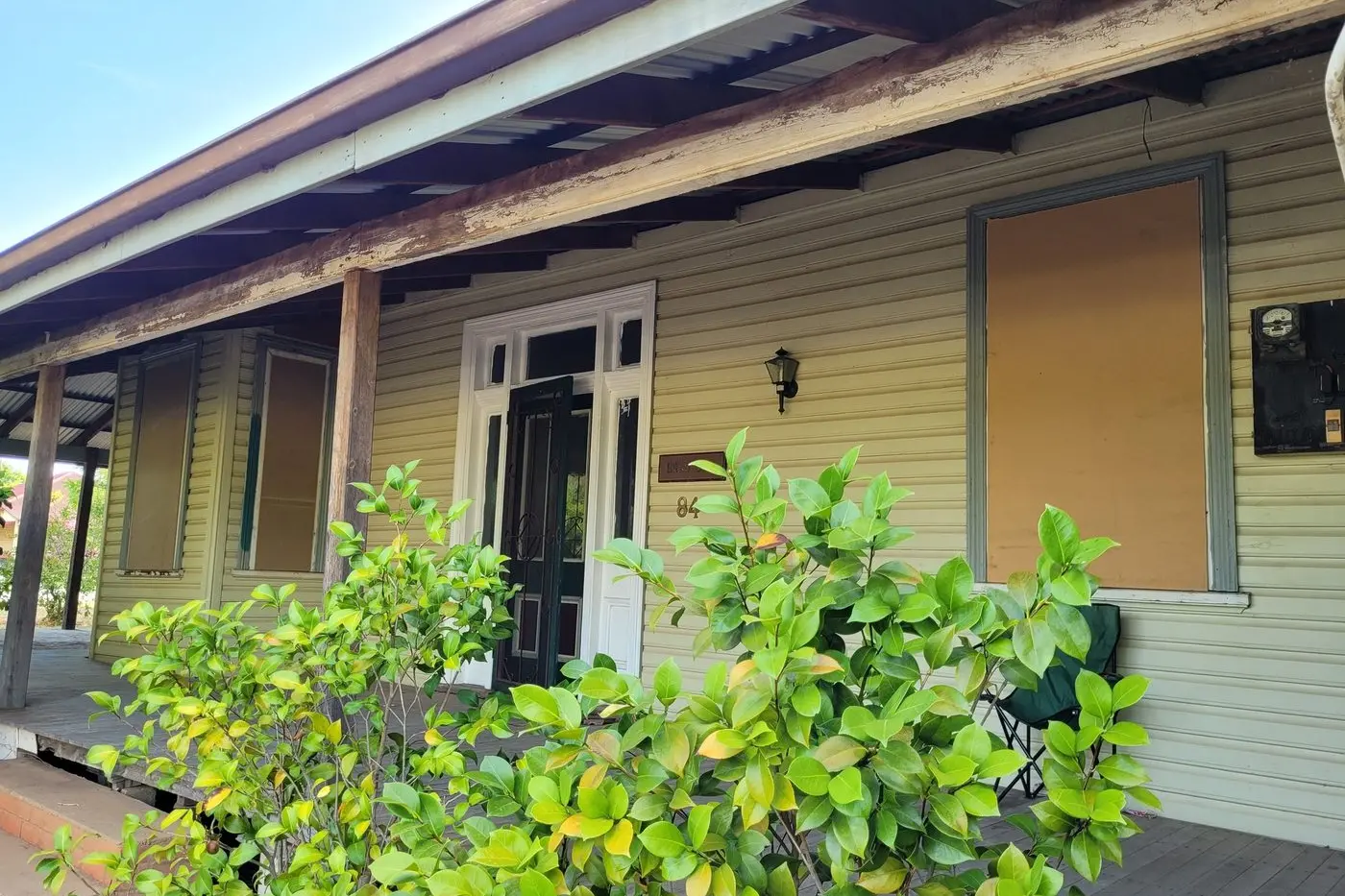 Boarded up windows on the house on the corner of Adams and Twynam Streets where the incident took place.