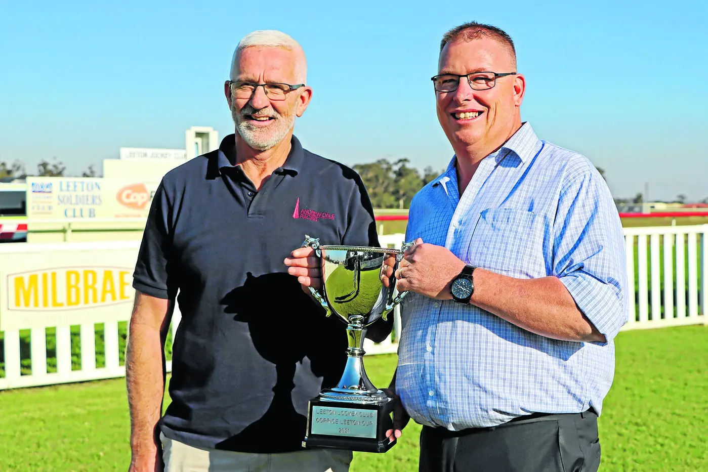 Trainer Andrew Dale receives the Leeton Cup from Dion Davis, Coprice. Photos: Kim Woods