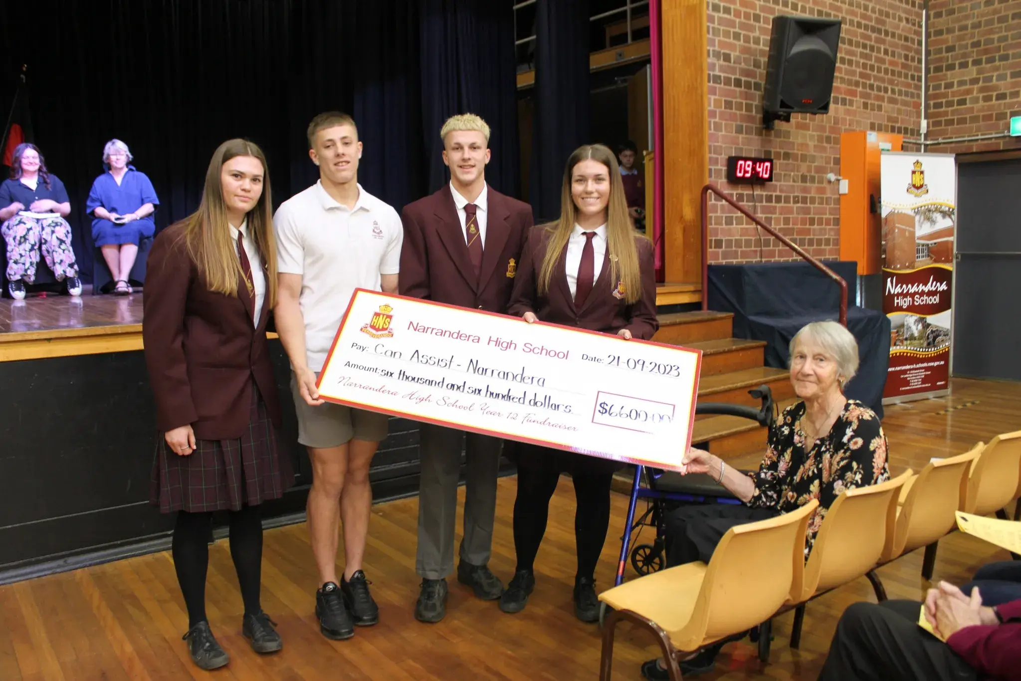 <p>NHS year 12 students presents president of CanAssist Neta Close a cheque from fundraising.</p>\\n
