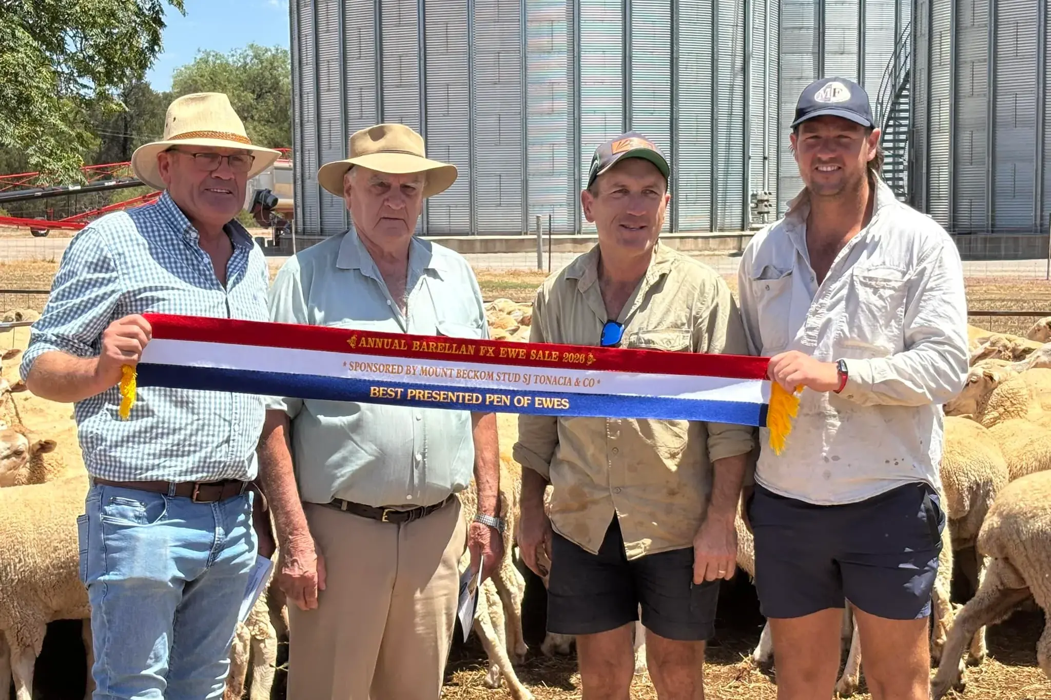 <p>Steve Grantham and Ian Tonacia awarding Mat Flagg and Jack Hillman the best presented pen of Ewe Lambs.</p>\\n