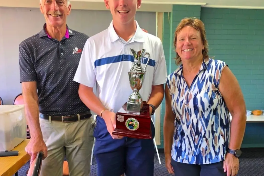 <p>Cooper Holman with the Ken Trimble Junior Open trophy alongside Ken Trimble (left) and Sameera Bashir junior golf coordinator.</p>\\n