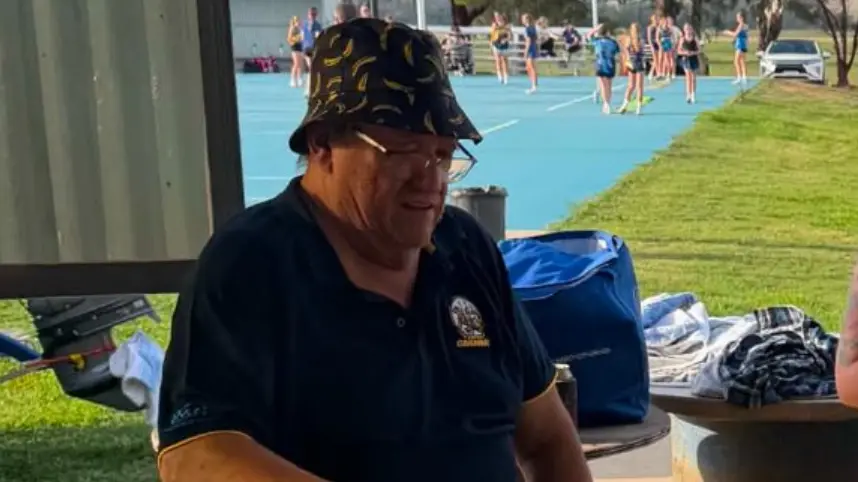 Volunteer honoured after cooking 80,000 snags for footy club over 21 years