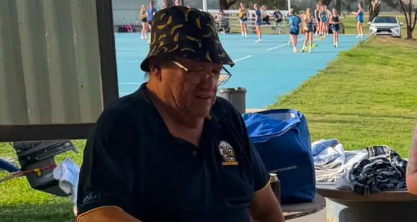 Volunteer honoured after cooking 80,000 snags for footy club over 21 years