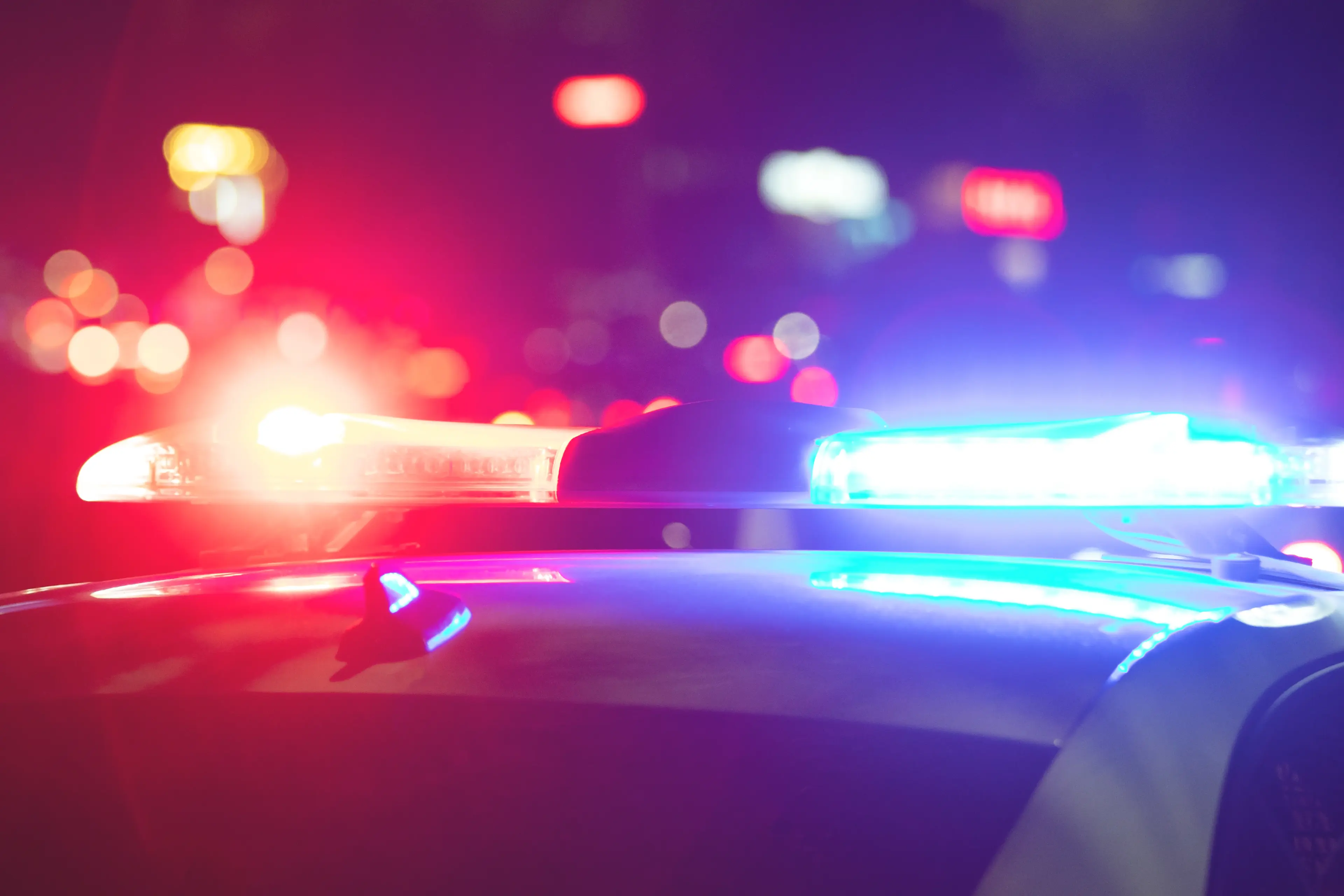 <p>Red and blue light flasher. Police car at night time in the city</p>\\n